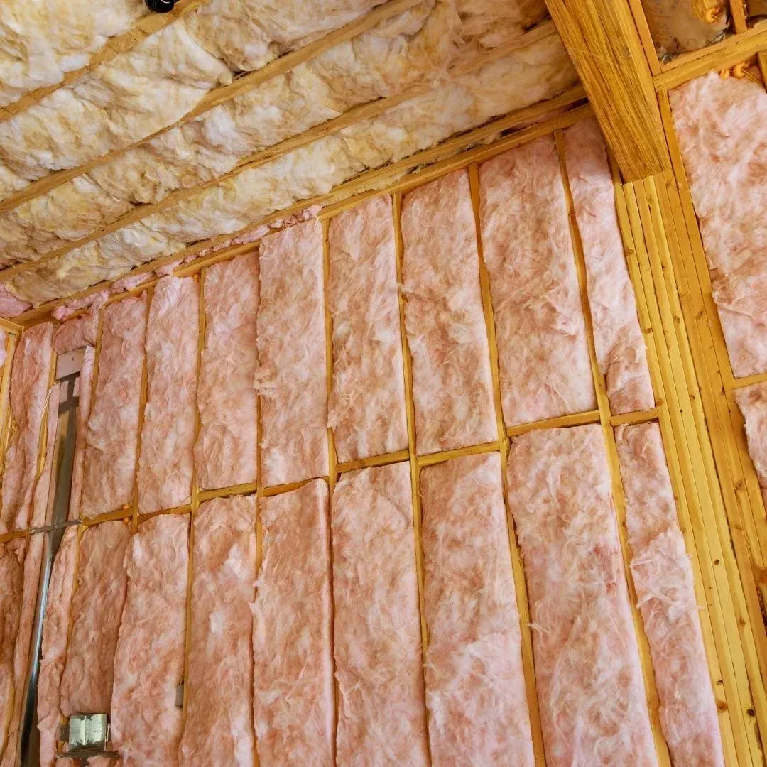 Fiberglass batt insulation installed between wall studs and ceiling joists in a Lubbock, TX property